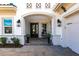 Inviting front porch with double doors, decorative accents, and manicured landscaping at 8265 Pavia Way, Bradenton, FL 34202