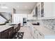 Elegant kitchen featuring custom white cabinetry, stainless steel appliances, and marble countertops at 8265 Pavia Way, Bradenton, FL 34202
