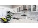 Bright kitchen with white cabinetry, granite countertops, stainless steel appliances, and an island sink at 8265 Pavia Way, Bradenton, FL 34202