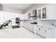 Bright kitchen with white cabinetry, granite countertops, stainless steel appliances, and an island sink at 8265 Pavia Way, Bradenton, FL 34202