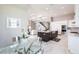 Open concept kitchen flows into the dining area, featuring an island and stainless steel appliances at 8265 Pavia Way, Bradenton, FL 34202