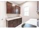 Well-equipped laundry room with ample cabinet space, granite countertops, and modern appliances for convenience at 8265 Pavia Way, Bradenton, FL 34202