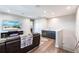 Stylish living room featuring a sofa, a TV and a bar area with a sink and storage at 8265 Pavia Way, Bradenton, FL 34202
