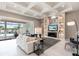 Bright living room with decorative ceilings, built-in shelving, fireplace, and an open view to the pool at 8265 Pavia Way, Bradenton, FL 34202