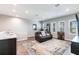 Inviting living room featuring a leather sofa, game machine, and stylish rug, perfect for relaxation and entertainment at 8265 Pavia Way, Bradenton, FL 34202