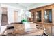 Living room showcasing an antique wooden cabinet, an upright piano, and open staircase at 8265 Pavia Way, Bradenton, FL 34202