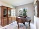 Living room with antique wooden cabinet, an upright piano, and a neutral color scheme at 8265 Pavia Way, Bradenton, FL 34202