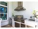 Elegant outdoor kitchen featuring stainless steel appliances and marble countertops at 8265 Pavia Way, Bradenton, FL 34202