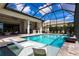 Relax in your screened-in pool and spa with stunning lake views at 8265 Pavia Way, Bradenton, FL 34202