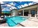 Gorgeous pool with a covered lanai, travertine tile, and a lovely water feature at 8265 Pavia Way, Bradenton, FL 34202