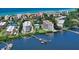 Scenic aerial view of waterfront condos, pool, and boat docks in the Turtle Bay community, Siesta Key, Florida at 8735 Midnight Pass Rd # 301B, Sarasota, FL 34242
