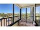 Enclosed balcony with seating area and clear views of the neighborhood at 8735 Midnight Pass Rd # 301B, Sarasota, FL 34242