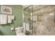 This bathroom features a glass shower with decorative tile surround and convenient shelving for toiletries at 8735 Midnight Pass Rd # 301B, Sarasota, FL 34242