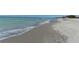 Inviting shoreline with gentle waves, clear waters, and soft sand, perfect for relaxation at 8735 Midnight Pass Rd # 301B, Sarasota, FL 34242