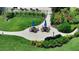Beautiful courtyard featuring outdoor dining areas with umbrella-shaded tables and lush green landscaping at 8735 Midnight Pass Rd # 301B, Sarasota, FL 34242