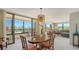 Open dining room with lovely pendant lighting fixture and views of the outdoor balcony at 8735 Midnight Pass Rd # 301B, Sarasota, FL 34242