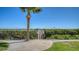 Scenic waterfront dock view with lush greenery and a clear blue sky at 8735 Midnight Pass Rd # 301B, Sarasota, FL 34242