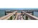 Scenic waterfront dock with benches and a view of the bay at 8735 Midnight Pass Rd # 301B, Sarasota, FL 34242