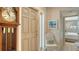 Entrance featuring a front door, chair, grandfather clock, and beach-themed wall art at 8735 Midnight Pass Rd # 301B, Sarasota, FL 34242