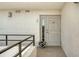 Front entrance featuring railing, large door with window, stucco wall, and white flower pot at 8735 Midnight Pass Rd # 301B, Sarasota, FL 34242