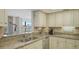 Kitchen featuring granite countertops, stainless steel appliances, and white cabinetry at 8735 Midnight Pass Rd # 301B, Sarasota, FL 34242