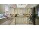 Kitchen with granite countertops, stainless steel appliances, and tiled flooring at 8735 Midnight Pass Rd # 301B, Sarasota, FL 34242