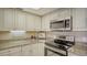 Bright kitchen featuring stainless steel appliances and granite countertops at 8735 Midnight Pass Rd # 301B, Sarasota, FL 34242