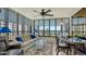 Enclosed lanai with comfortable seating and dining area offers stunning waterfront views and plenty of natural light at 8735 Midnight Pass Rd # 301B, Sarasota, FL 34242
