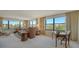 Spacious living room with comfortable seating, large windows, and bright natural lighting at 8735 Midnight Pass Rd # 301B, Sarasota, FL 34242