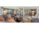 Spacious living room featuring comfortable seating, display cabinets, and views of the water at 8735 Midnight Pass Rd # 301B, Sarasota, FL 34242