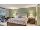 Spacious main bedroom with a plush king-size bed and access to an enclosed lanai with waterfront views at 8735 Midnight Pass Rd # 301B, Sarasota, FL 34242