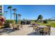 Outdoor patio with multiple tables, chairs, and BBQ grills at 8735 Midnight Pass Rd # 301B, Sarasota, FL 34242