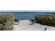 A lovely waterfront view from the Turtle Bay community with chairs and a view of the bay at 8735 Midnight Pass Rd # 301B, Sarasota, FL 34242