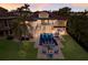 Stunning aerial view of a luxurious home featuring a large pool, spa, fire pit, and lush landscaping at 875 Siesta Key Cir, Sarasota, FL 34242