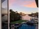 Beautiful backyard view featuring a waterfront pool, boat dock, and lush landscaping at 875 Siesta Key Cir, Sarasota, FL 34242