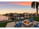 Waterfront backyard featuring dock, fire pit, and canal views at 875 Siesta Key Cir, Sarasota, FL 34242
