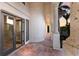 Covered balcony showcasing stone columns and tile flooring overlooking lush landscaping at 875 Siesta Key Cir, Sarasota, FL 34242