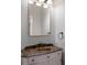 Small bathroom with bronze fixtures, and an elegantly styled vanity at 875 Siesta Key Cir, Sarasota, FL 34242