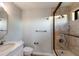 Modern bathroom featuring tiled shower with glass door and marble vanity at 875 Siesta Key Cir, Sarasota, FL 34242