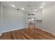 Light-filled bedroom showcasing hardwood floors and a view into the kitchen at 875 Siesta Key Cir, Sarasota, FL 34242