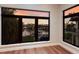 Waterfront views from a room featuring large windows and beautiful hardwood floors at 875 Siesta Key Cir, Sarasota, FL 34242