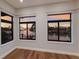 Bedroom featuring large windows with waterfront views and beautiful hardwood floors at 875 Siesta Key Cir, Sarasota, FL 34242