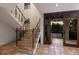 Elegant foyer with patterned tile staircase leading to the next level and an open doorway, showcasing the home's details at 875 Siesta Key Cir, Sarasota, FL 34242