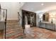 Elegant foyer with patterned tile staircase leading to the next level and an open doorway, showcasing the home's details at 875 Siesta Key Cir, Sarasota, FL 34242