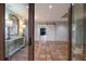 Warm foyer with terra cotta tile and view of a sliding barn door at 875 Siesta Key Cir, Sarasota, FL 34242