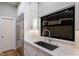 Modern kitchen features a stainless steel refrigerator, undermount sink and bright white cabinets at 875 Siesta Key Cir, Sarasota, FL 34242