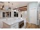 Bright kitchen with large island, stainless appliances, hardwood floors, and stylish pendant lighting at 875 Siesta Key Cir, Sarasota, FL 34242