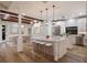 Modern kitchen with white cabinetry, large island, and stainless steel appliances at 875 Siesta Key Cir, Sarasota, FL 34242