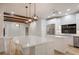 Contemporary kitchen featuring a large center island with bar seating and modern stainless appliances at 875 Siesta Key Cir, Sarasota, FL 34242