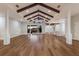 Bright living room boasts wooden floors, vaulted ceiling with wood beams, and sliding doors to the outdoor space at 875 Siesta Key Cir, Sarasota, FL 34242